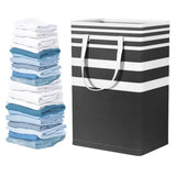 a black and white striped shopping bag with a stack of folded clothes