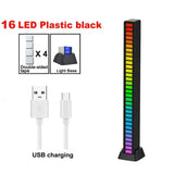 A black and white usb charging stand with a rainbow colored led strip