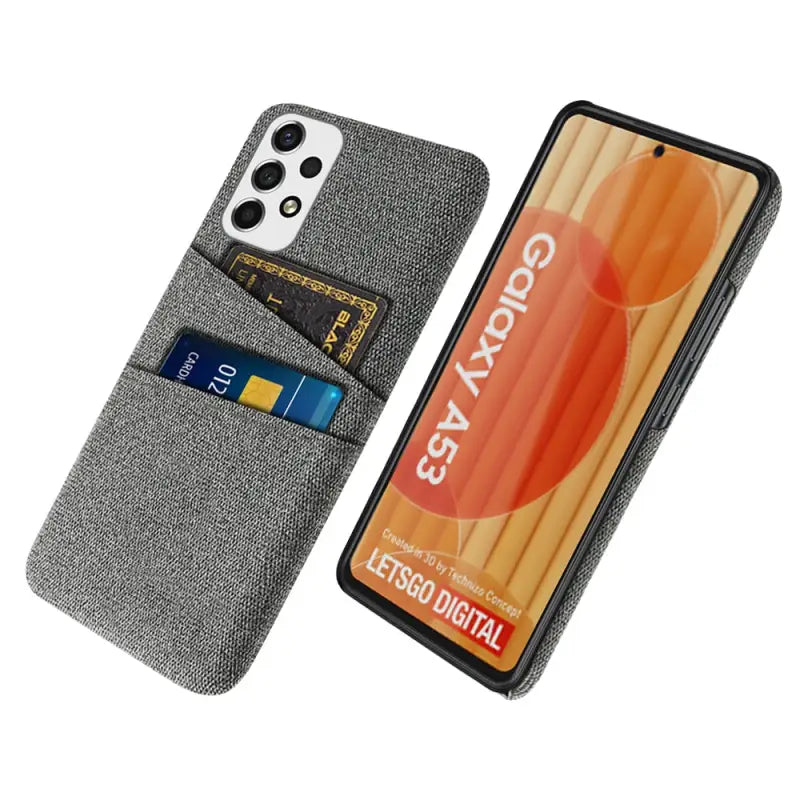the back of a gray denim wallet case with a credit card slot