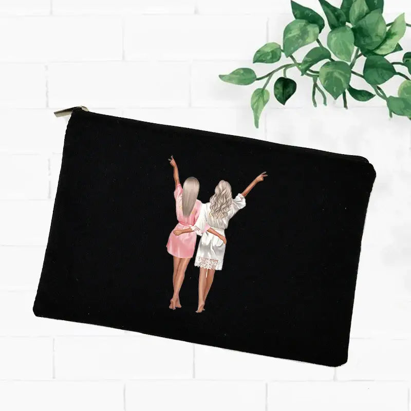 a black zipper pouch with a girl in a pink dress