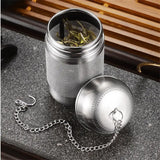 a stainless tea infuser with a chain around it