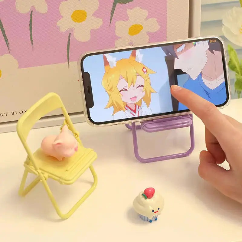 a person taking a picture of a doll on a phone