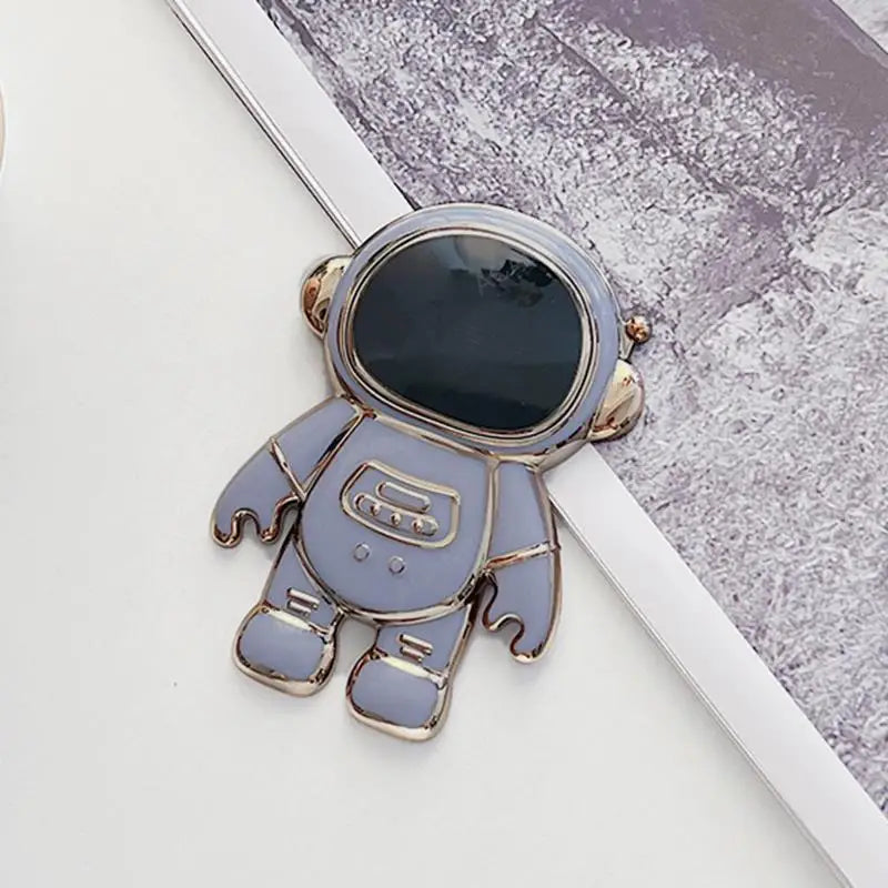 a blue astronaut pin with a black face