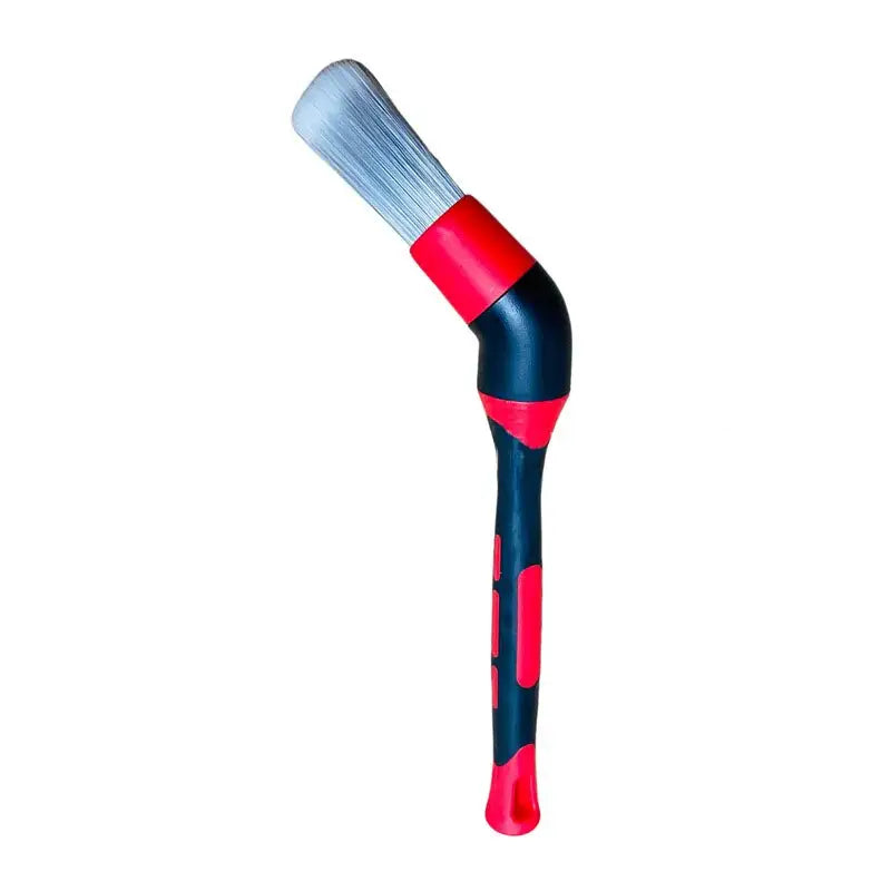 a red and black brush with a white handle