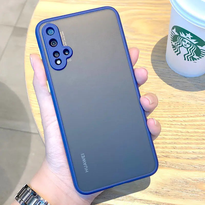 a hand holding a blue case with a starbucks cup in the background