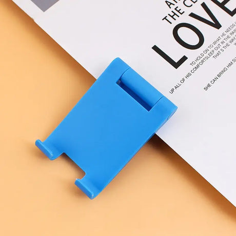 a blue plastic clip on top of a white paper