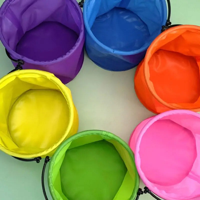 a rainbow colored bucket with a black handle