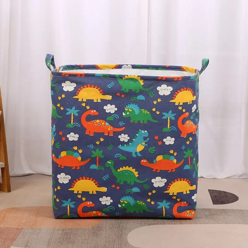 a blue fabric storage bag with dinosaurs on it