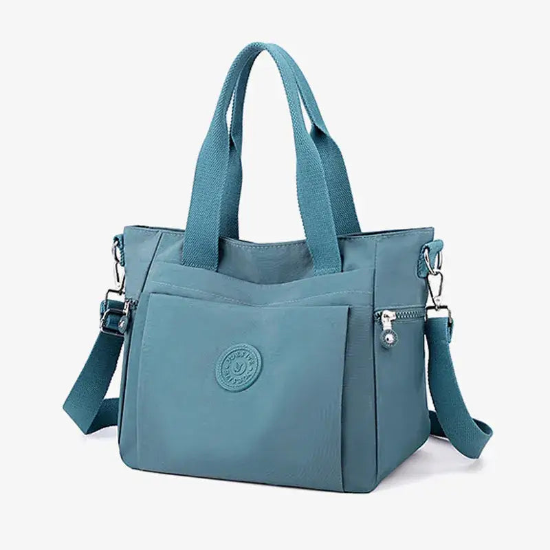 a blue handbag with a zipper closure