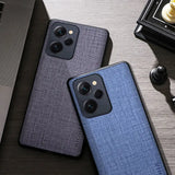 the back of a blue iphone case next to a laptop