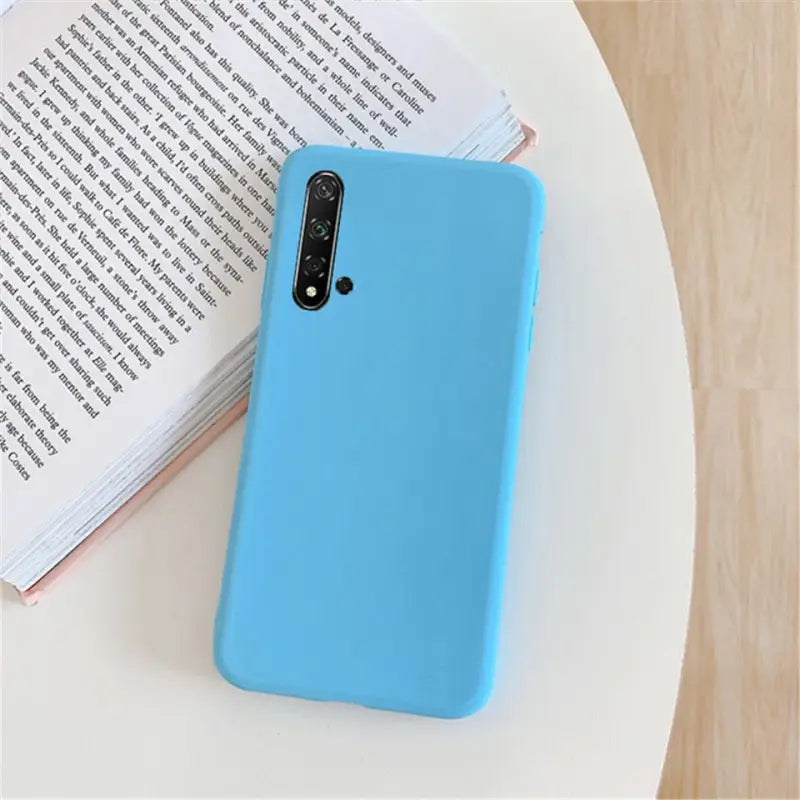 a blue iphone case sitting on a table