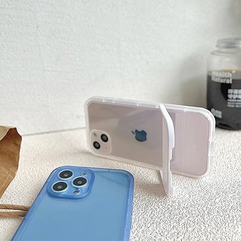 a blue iphone case sitting next to a white iphone