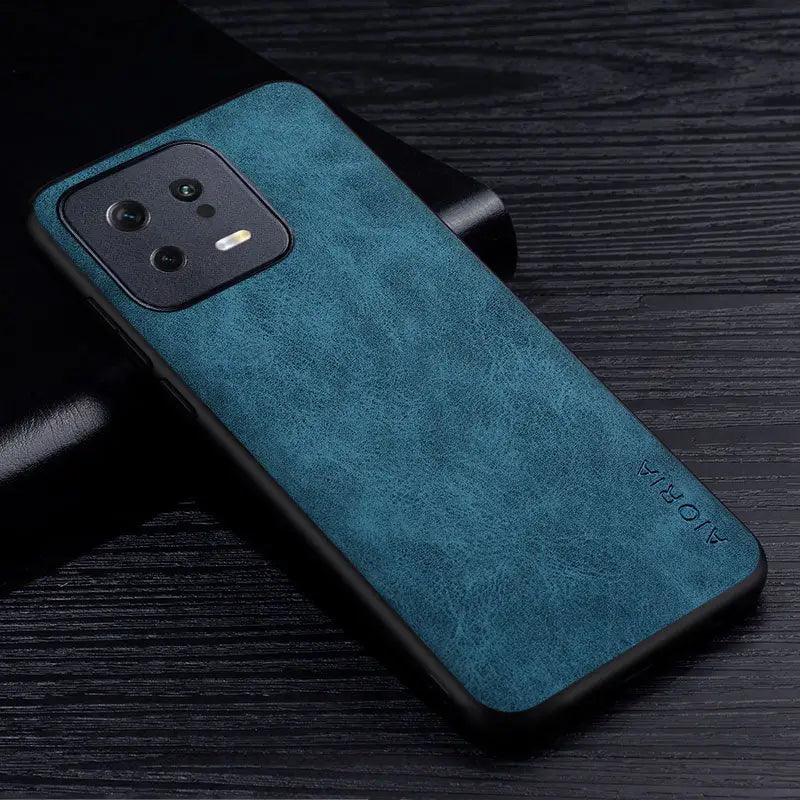 the back of a blue leather case on a black table