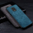 the back of a blue leather case with a black leather cover