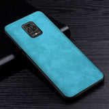 the back of a blue leather case on a black table