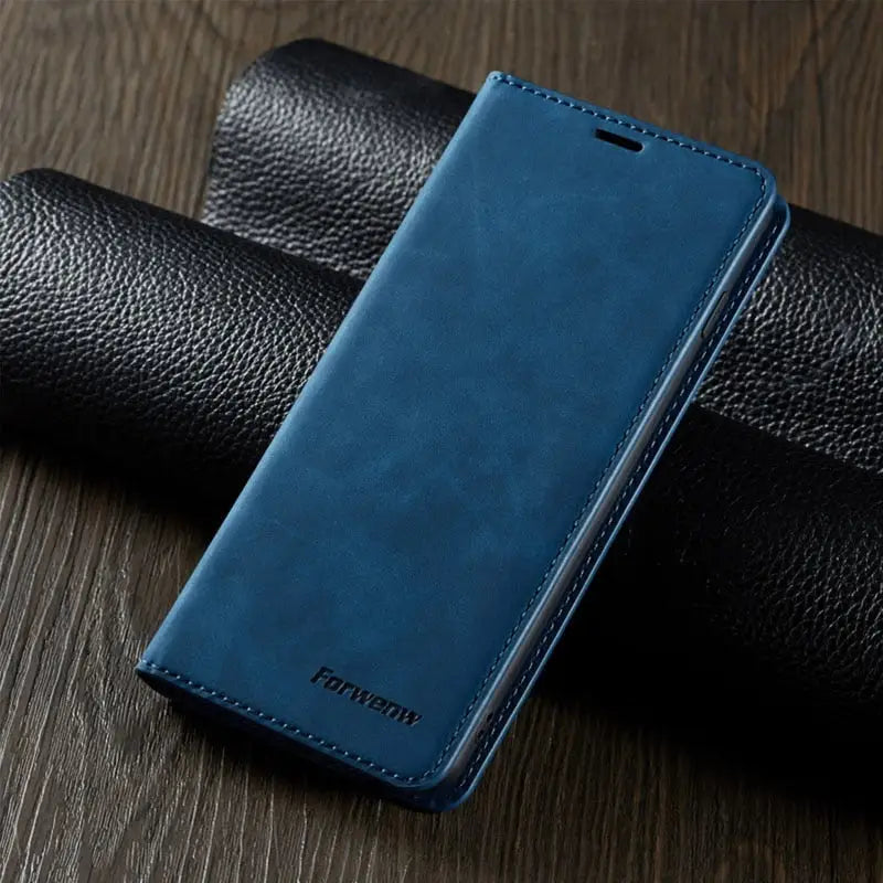 the back of a blue leather case on a wooden table