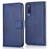 the back of a blue leather case with a leather wallet