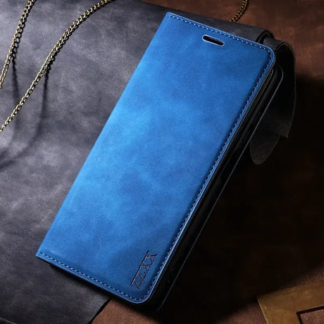 The blue leather wallet case is shown on a brown leather surface