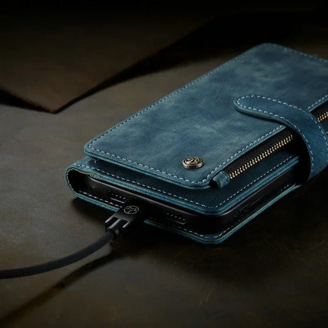 Blue leather wallet-style phone case with a zipper compartment and charging cable attached.