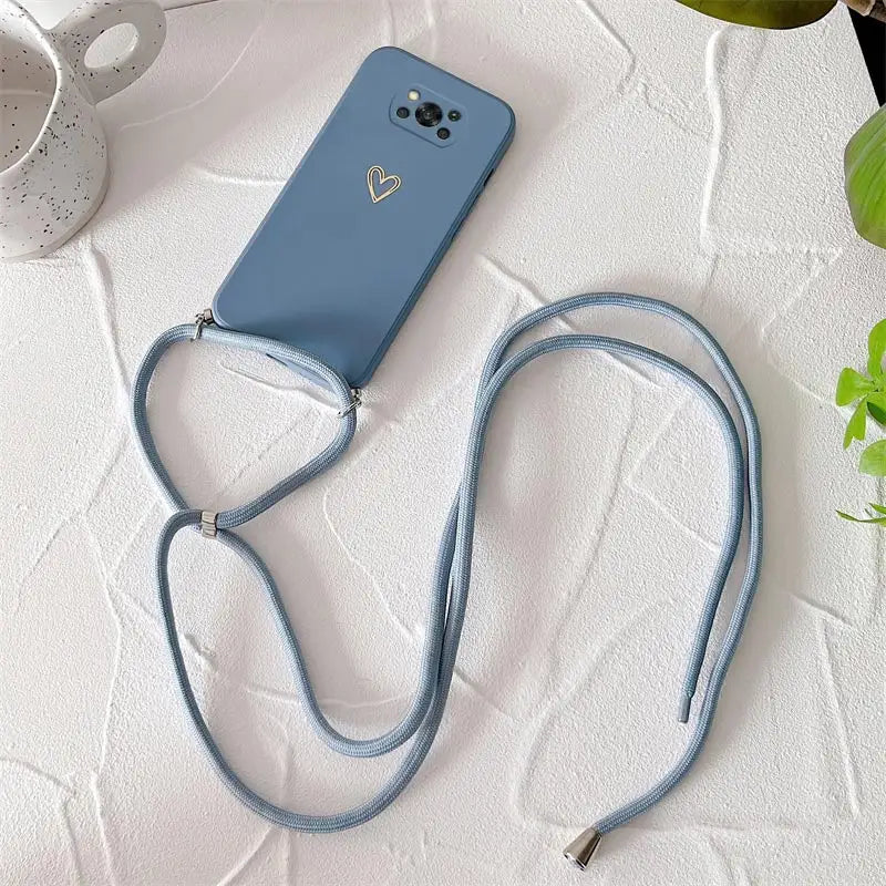 a blue phone case with a strap and a white cup