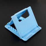 a blue plastic phone holder on a black surface