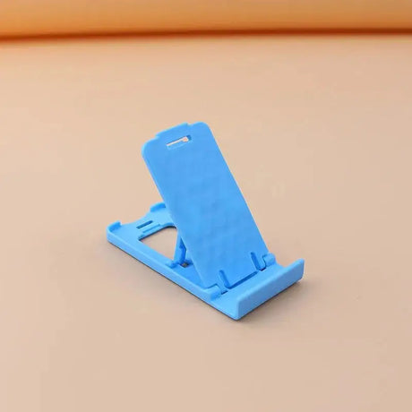 a blue phone stand on a beige surface