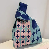 there is a blue and pink purse with a blue and pink pattern