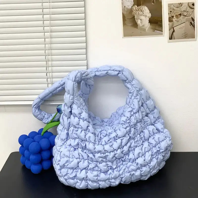 a blue purse sitting on top of a table