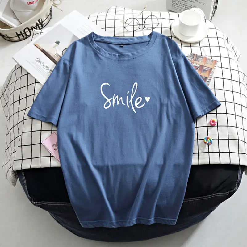 a blue t - shirt with the word smile on it