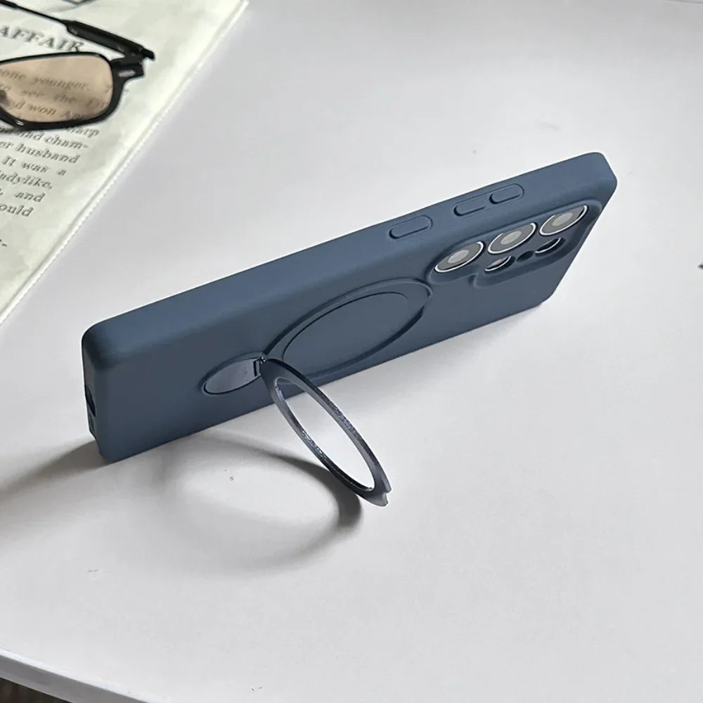 A blue silicone phone case with a built-in magnetic ring stand.