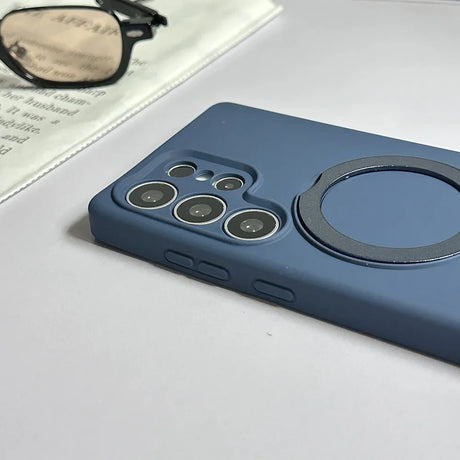 Blue silicone phone case with a camera cutout and an integrated magnetic ring.