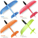 four different colors of plastic gliders with black handles and a red one
