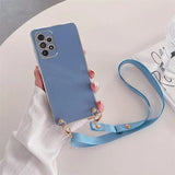 Blue smartphone with a multi-lens camera and attached blue wrist strap.