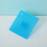 a blue plastic square with a hole in the middle