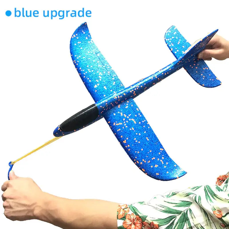 a hand holding a blue plastic airplane