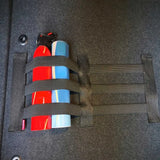 a car trunk with a seat belt and a bottle