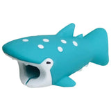 a blue toy shark with white spots on it’s body