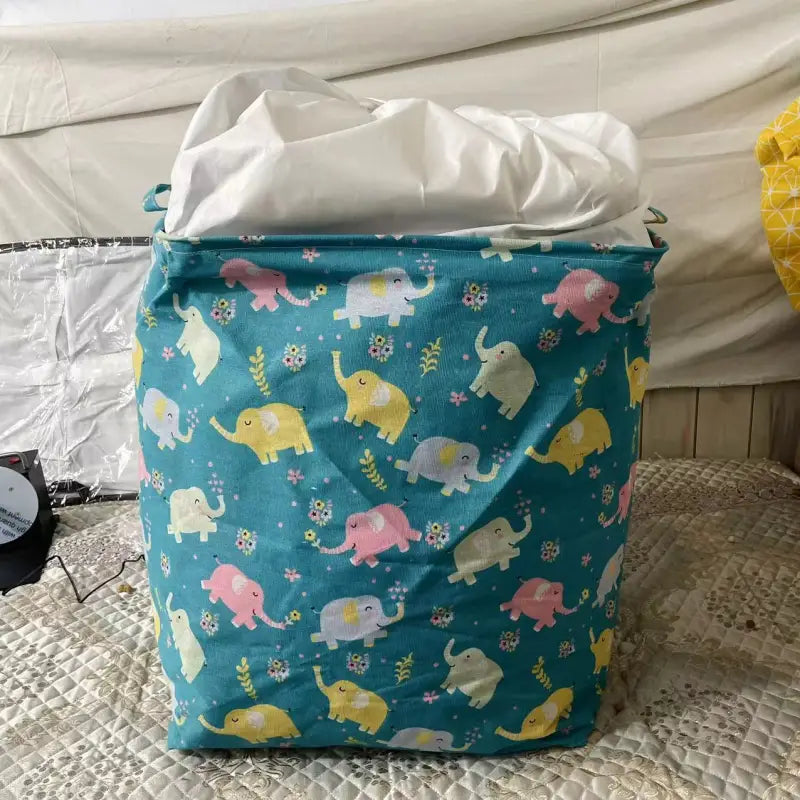 a blue and yellow elephant print laundry bag