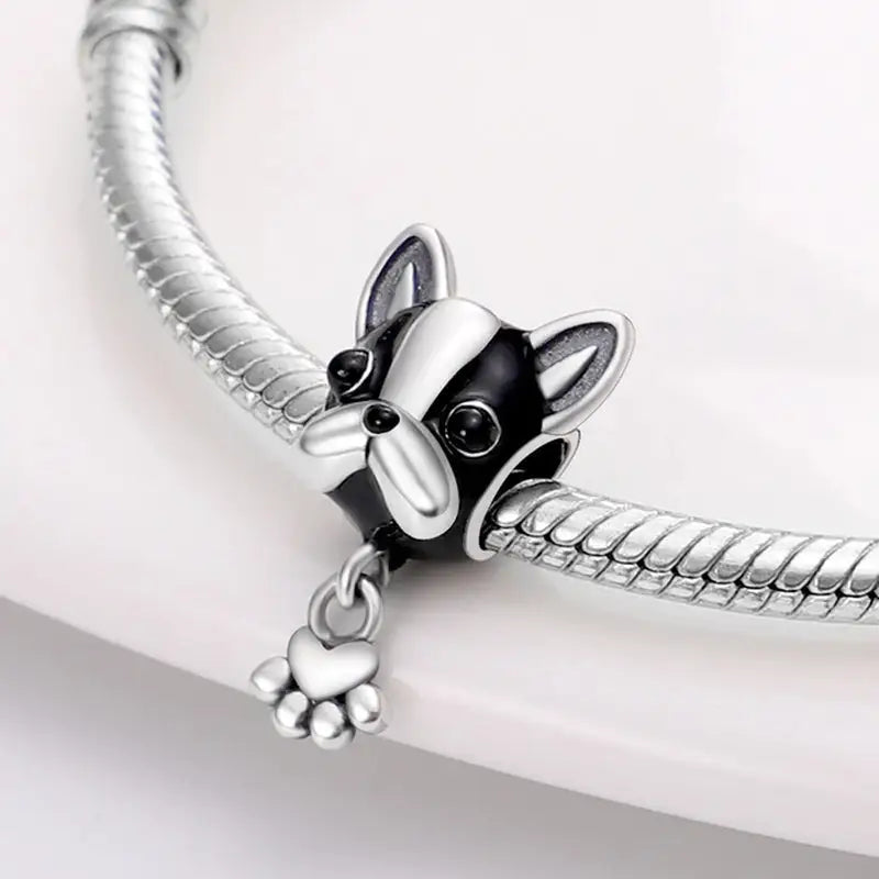 a silver bracelet with a dog charm