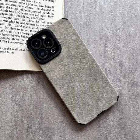 The book iphone case is shown on a book