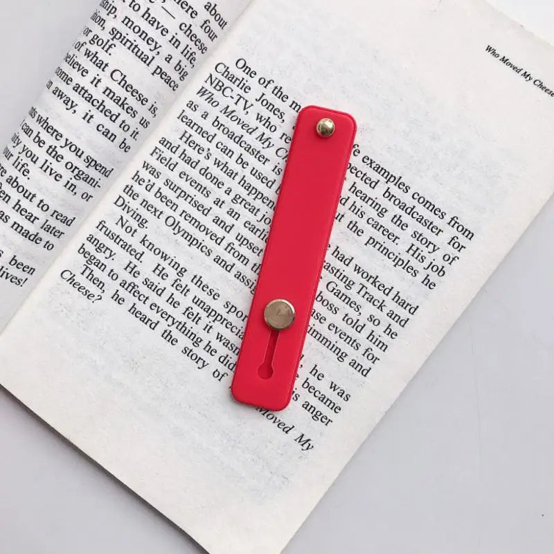 a red bookmark with a bookmark attached to it