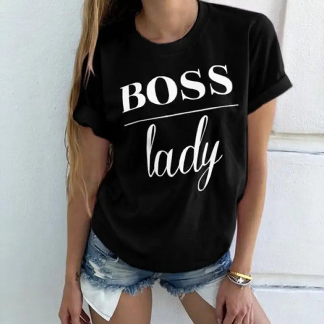 a woman wearing a black t shirt with the words boss lady