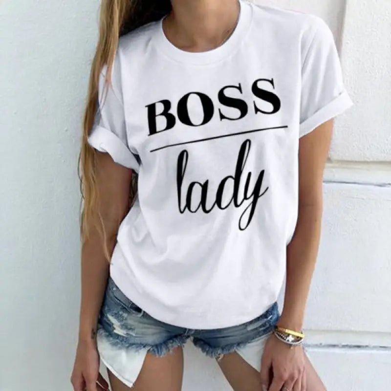 a woman wearing a white t shirt with the words boss lady