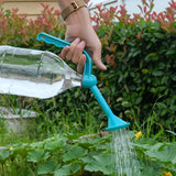 a person watering water in a garden