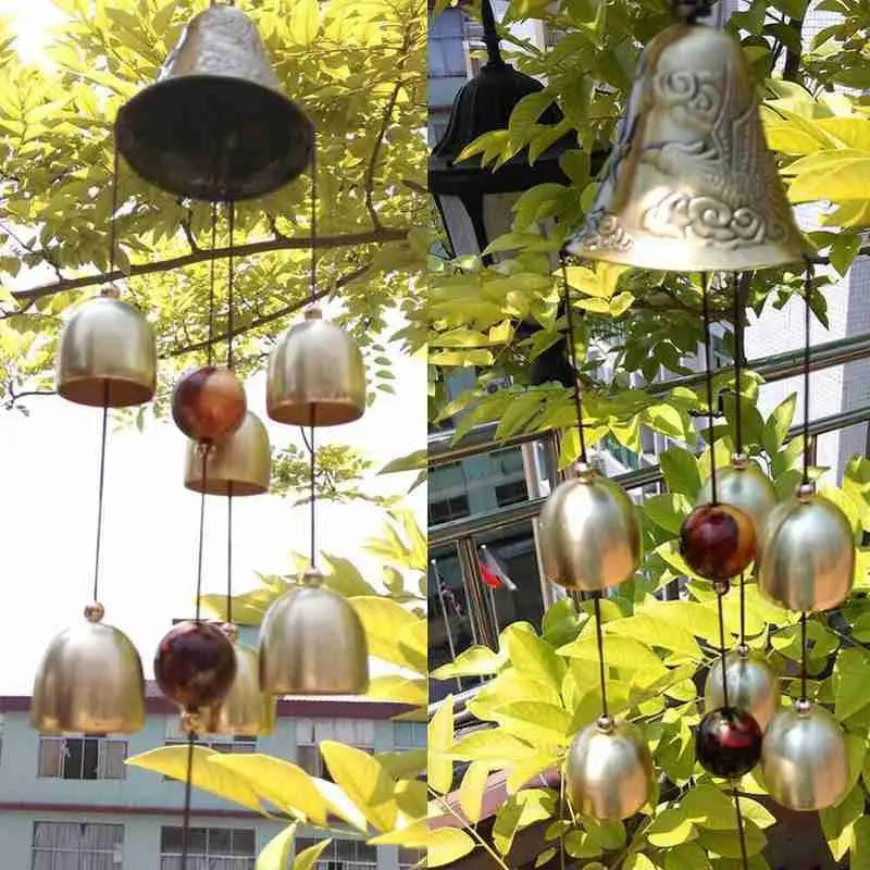 a bunch of bells hanging from a tree