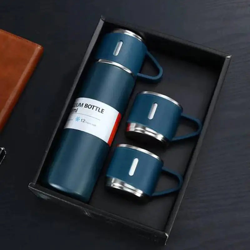 a box with two coffee mugs and a leather case