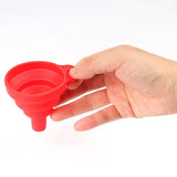 a hand holding a red plastic cup