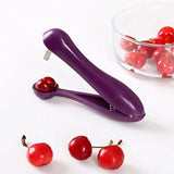 a bowl of cher and a purple cherry peeler