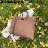 a brown bag sitting on top of a green grass field