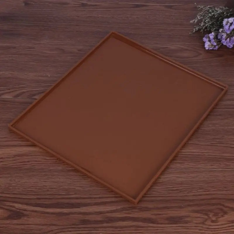 a brown square plate on a wooden table